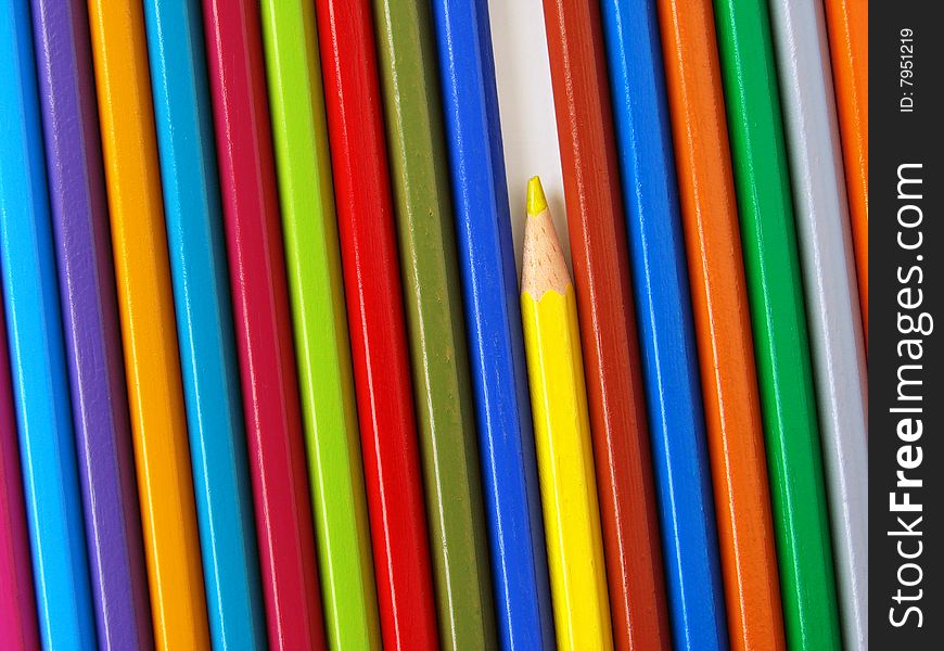 Yellow pencil among colorful ones set