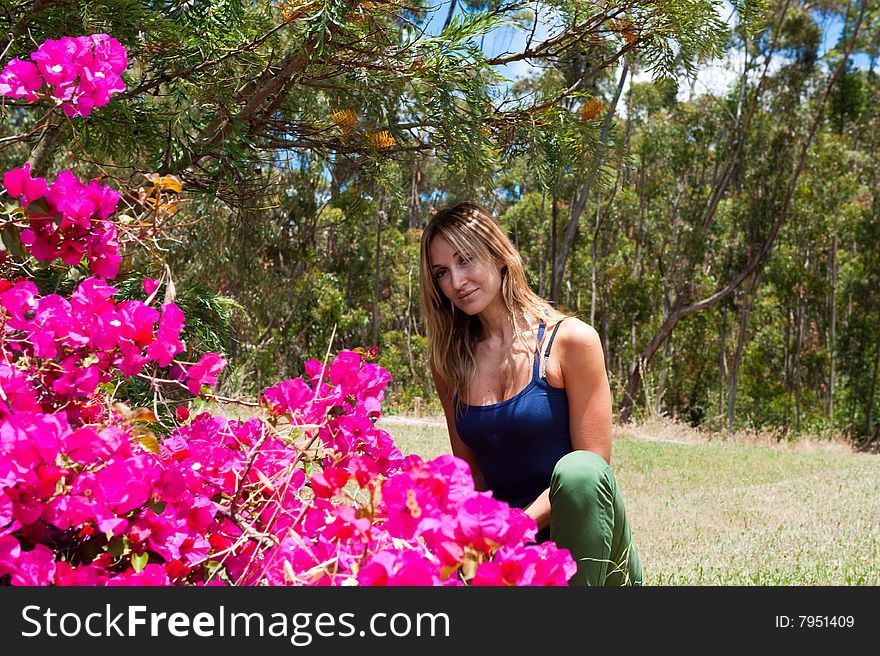 Woman front of bugonvia flowers. Woman front of bugonvia flowers