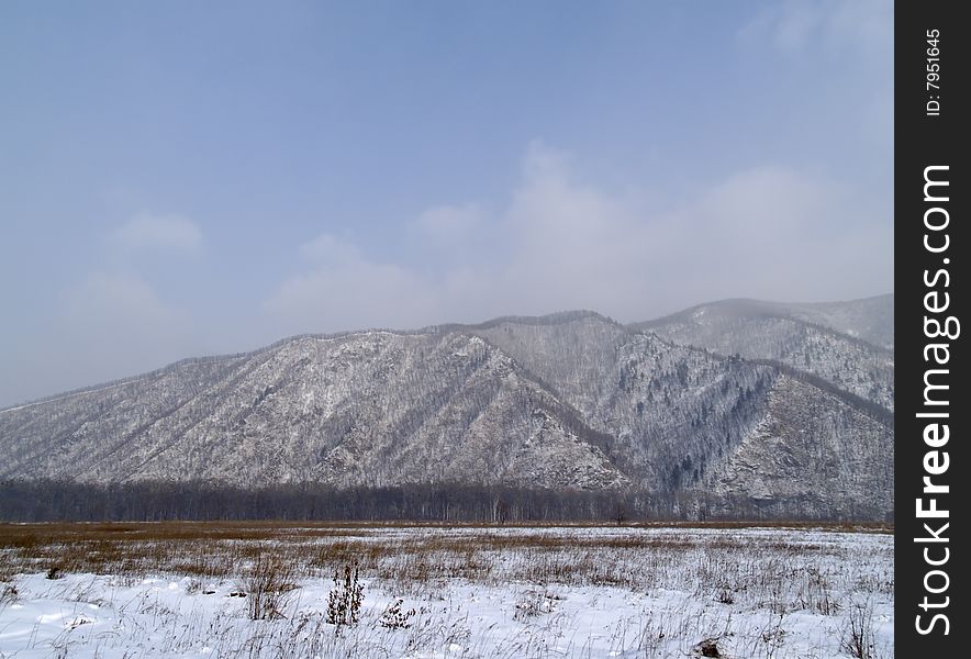 Winter landscape with a kind on a mountain ridge. Winter landscape with a kind on a mountain ridge