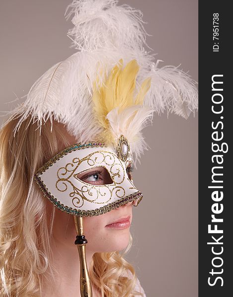 Beautiful young woman with Venetian mask, studio photo. Beautiful young woman with Venetian mask, studio photo