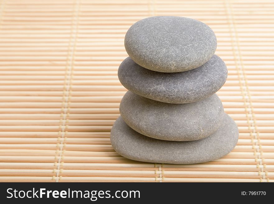 Balanced stones isolated in bamboo background
