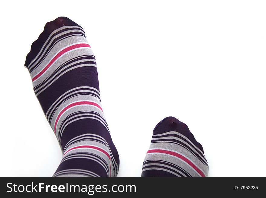 Beautiful legs in funny socks over white