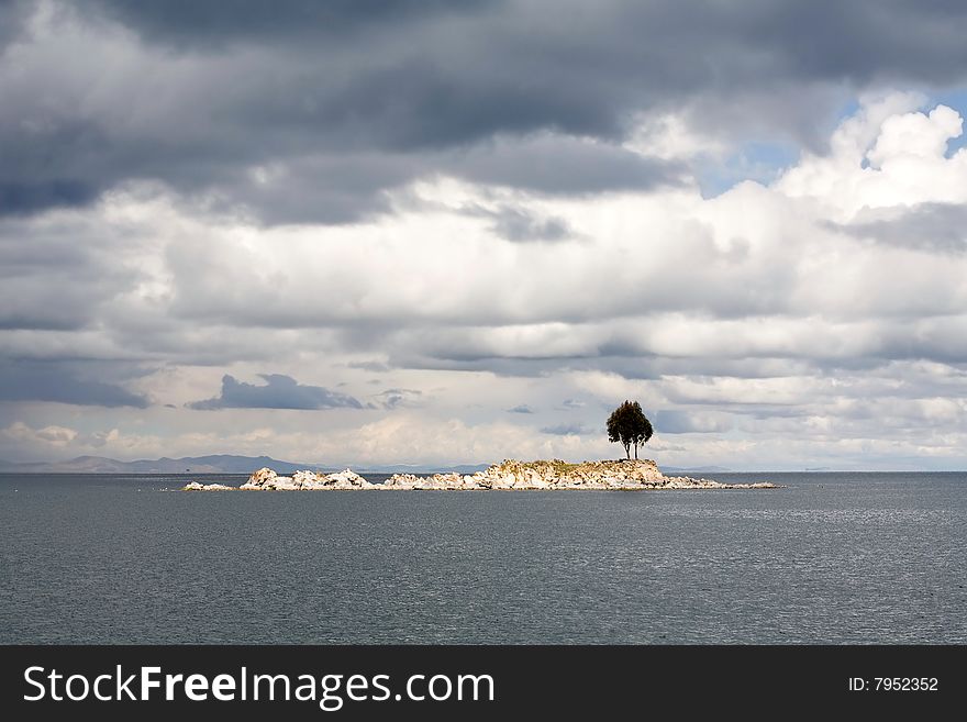 A single tree on and rocky island on Lake Titicaca. A single tree on and rocky island on Lake Titicaca.