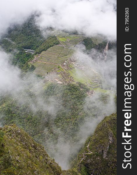 Machu Picchu is a pre-Columbian Inca site located 2,430 metres (8,000 ft) above sea level. It is situated on a mountain ridge above the Urubamba Valley in Peru, which is 80 kilometres (50 mi) northwest of Cusco and through which the Urubamba River flows. The river is a partially navigable headwater of the Amazon River. Often referred to as The Lost City of the Incas, Machu Picchu is one of the m