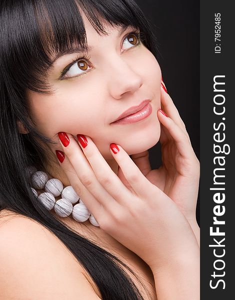 Portrait of the charming woman on black background