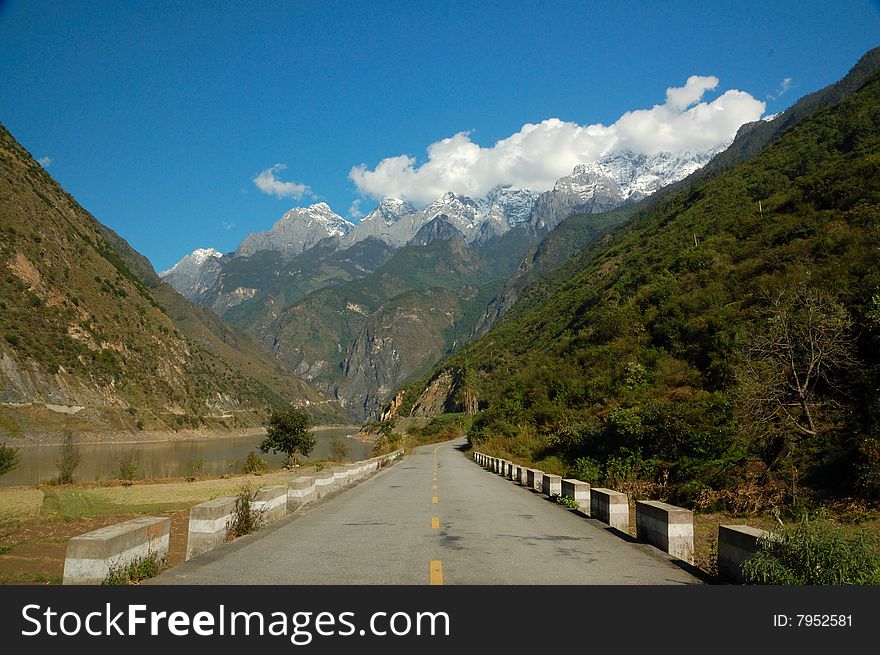 Road and jade dragon mountain at the end. Road and jade dragon mountain at the end