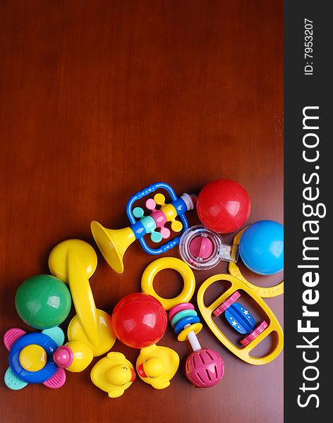 Infant rings and colorful balls on wooden table