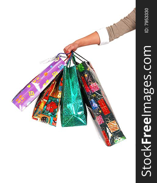 A woman's arm holding several colorful shopping bags in the picture with white background. A woman's arm holding several colorful shopping bags in the picture with white background.