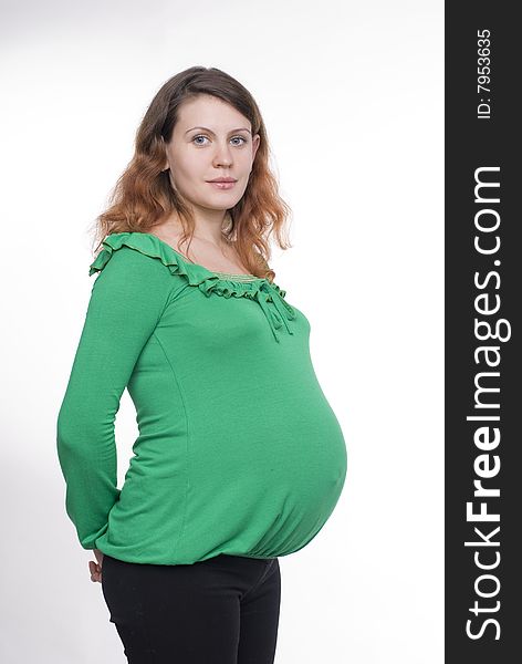 Studio portrait of the beautiful pregnant woman. Studio portrait of the beautiful pregnant woman