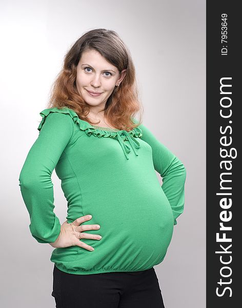 Studio portrait of the beautiful pregnant woman with funny emotions