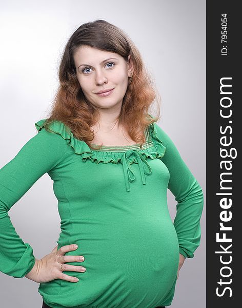 Beautiful pregnant girl is looking at the camera. Beautiful pregnant girl is looking at the camera
