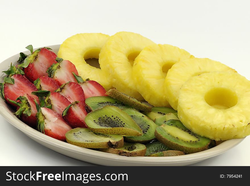 Fruit platter containing strawberries, kiwi fruits and pineapple slices. Fruit platter containing strawberries, kiwi fruits and pineapple slices