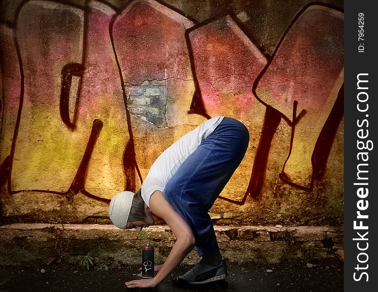 Young woman looking a air spray on a graffiti background