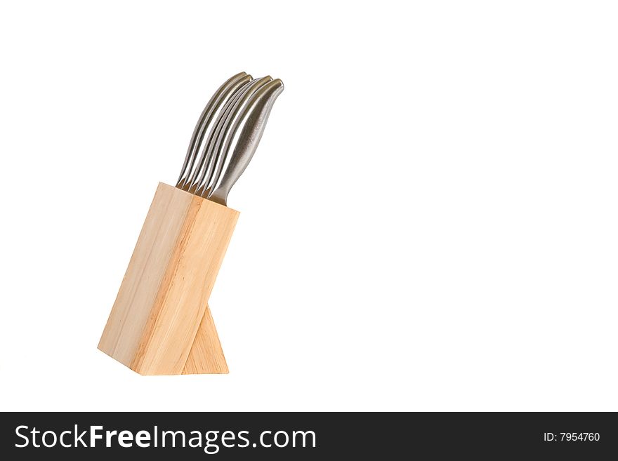 Stainless steel kitchen knives in wooden block