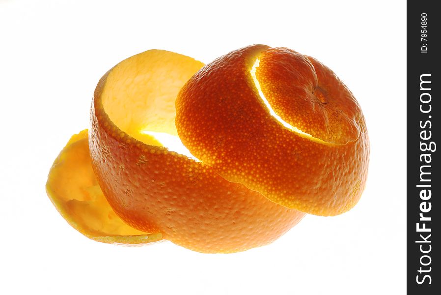 An orange hide is cut with a spiral on a white background