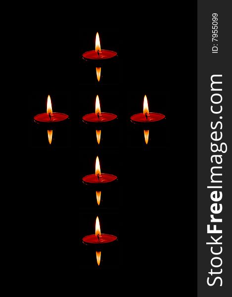 Six candles floating on the water shaped as cross. Six candles floating on the water shaped as cross