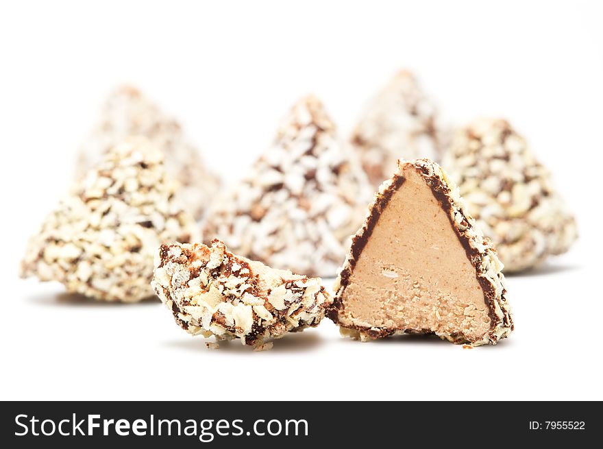 Cut chocolates isolated on a white background. Background blurry.