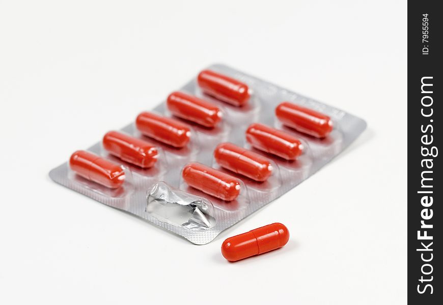 Orange Medicine capsule pills in a packet. Orange Medicine capsule pills in a packet