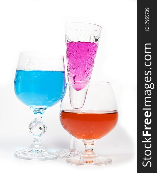 Three wineglass with drink blue and magenta colors