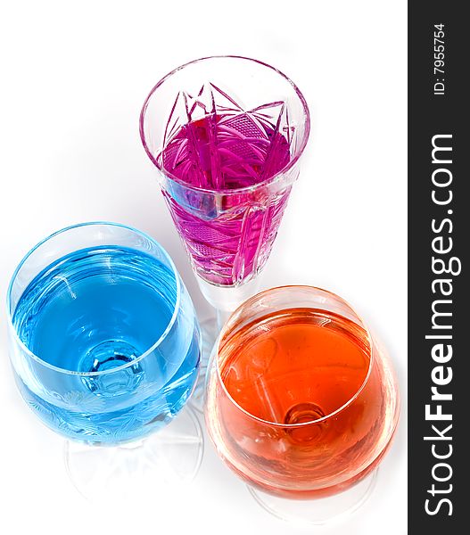 Three wineglass with drink blue and magenta colors