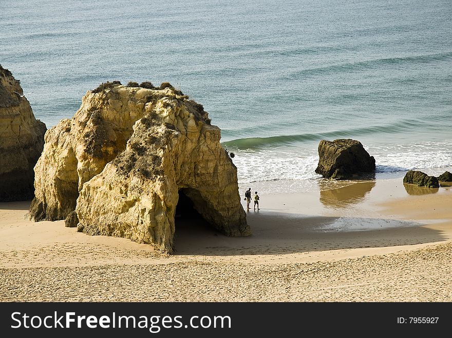 2 tourists walk in Praia da Rocha, Portimao, Algarve