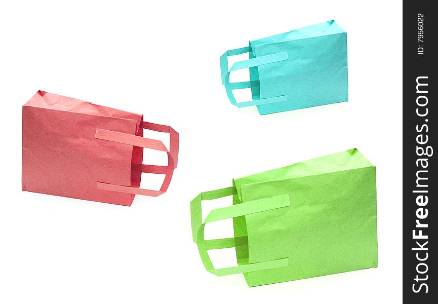 Shot of three coloured paper bags on white