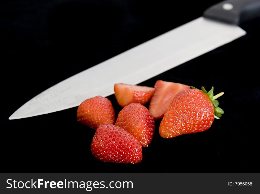 Freshly cut strawberries on black backround