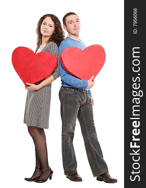 Couple standing holding hearts  isolated over white background