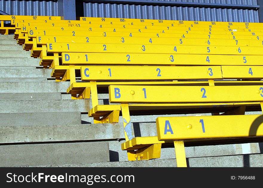 Rows of yellow numbered grandstand seating.