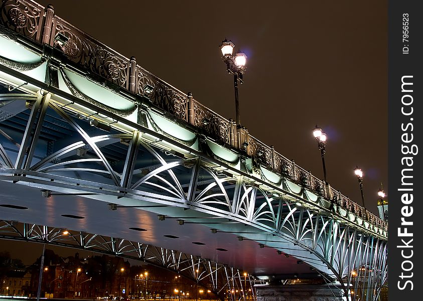 Highlighted bridge over the river at night