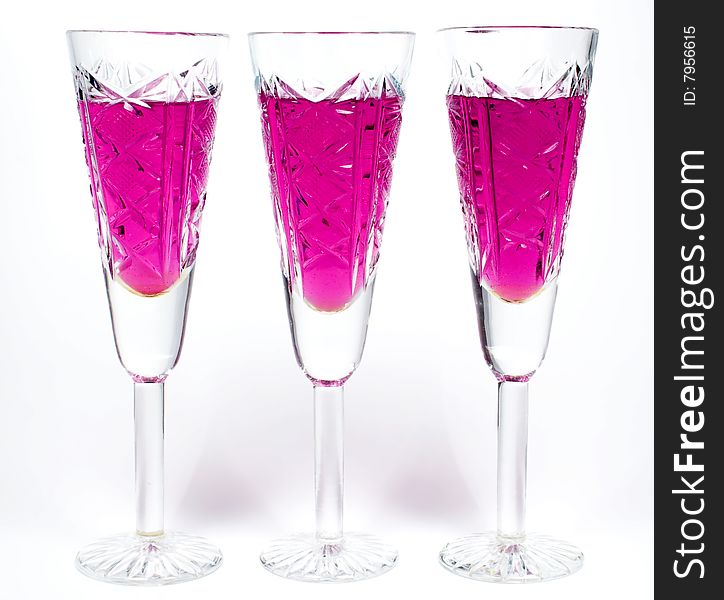 Three wineglass with drink and magenta colors