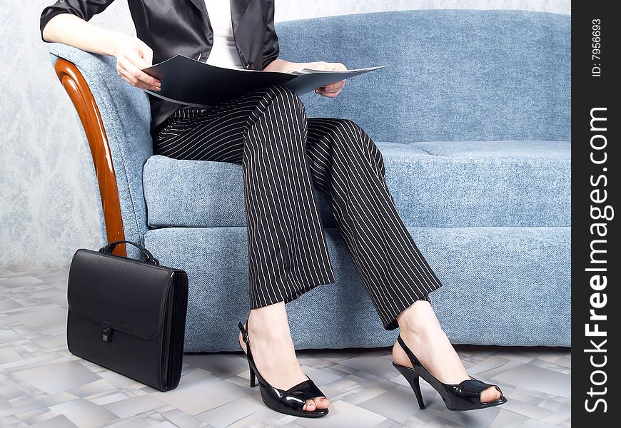 Businesswoman at office sitting on a sofa