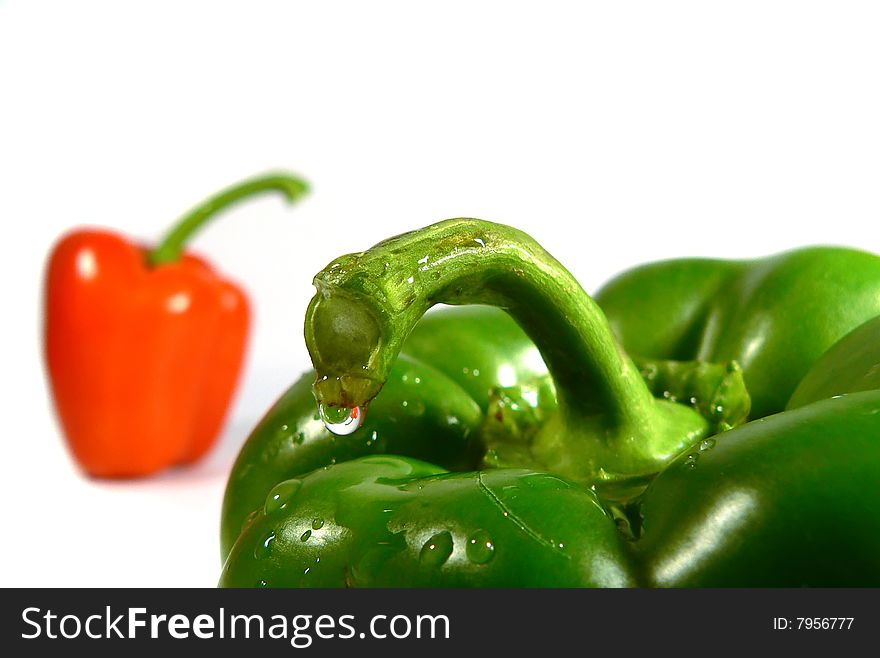 Green and red paprika background close up of water drop on paprika. Green and red paprika background close up of water drop on paprika