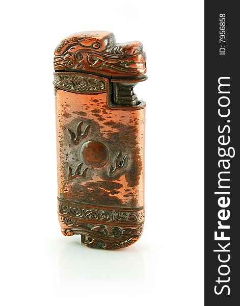Old bronze gas lighter isolated on a white background