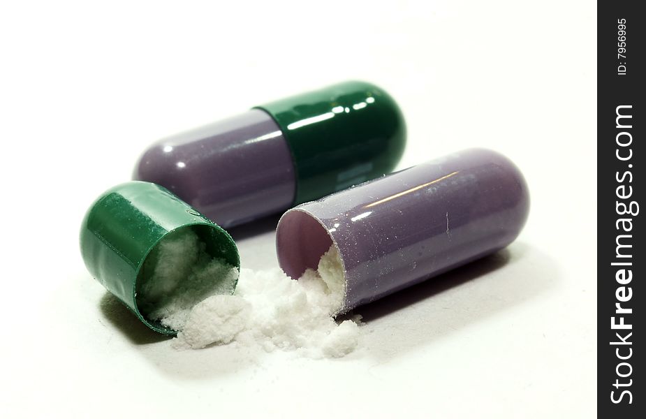 Open capsule of a medicine with a powder and the closed capsule of the same kind. Open capsule of a medicine with a powder and the closed capsule of the same kind