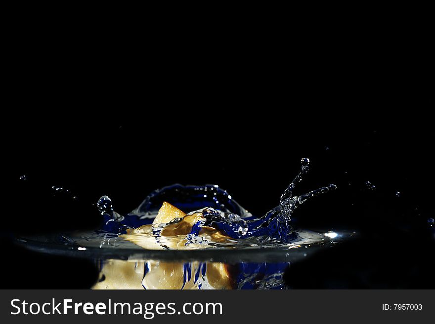 High-speed shooting of water with a slice of an apple falling in it