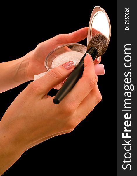 Female hands and cosmetic accessories on a black background - it is isolated. Female hands and cosmetic accessories on a black background - it is isolated.