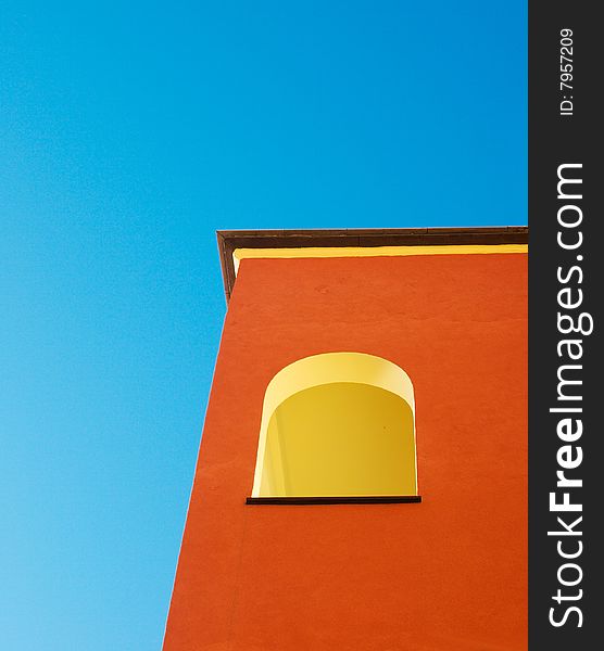 A colorful italian  building against a deep blue sky. A colorful italian  building against a deep blue sky.