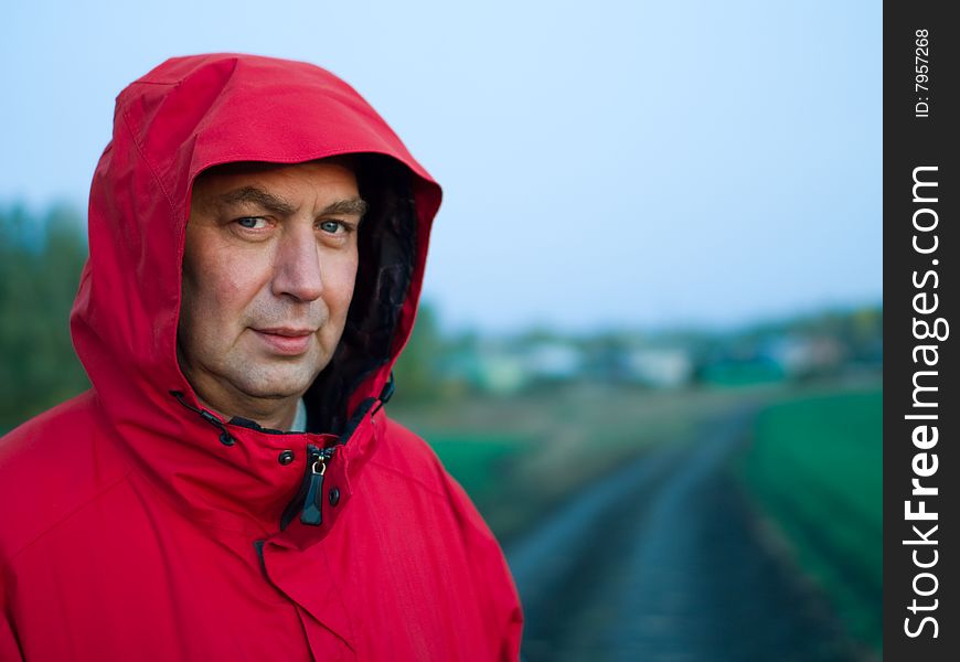 Portrait of man in red jacket outdoors - soft focus, shallow DOF. Portrait of man in red jacket outdoors - soft focus, shallow DOF