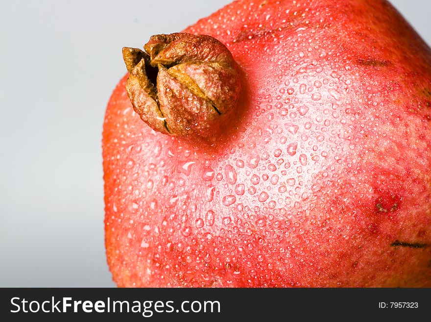 Pomegranate fruit with water drops.