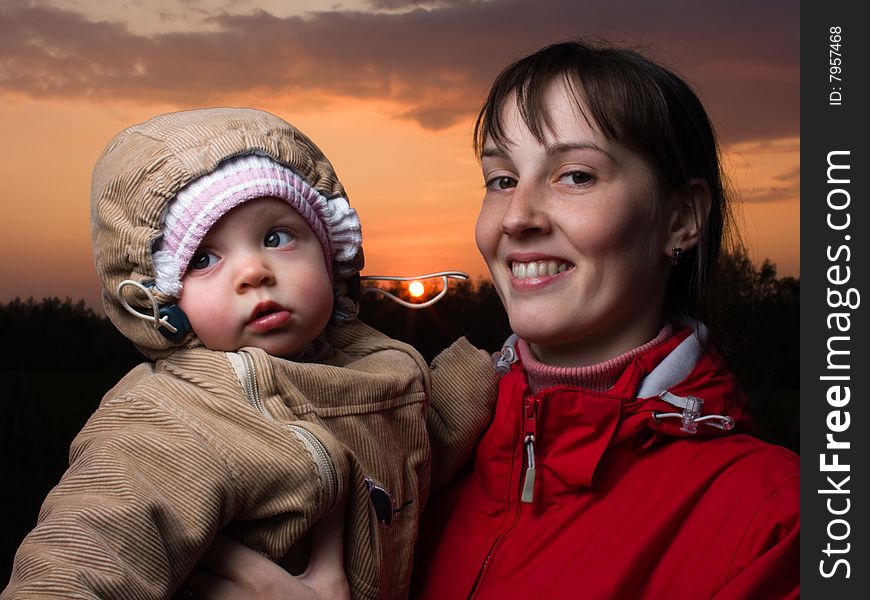 Portrait of baby with mom - against the sun