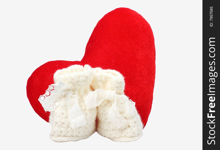Heart and baby's bootee on white background
