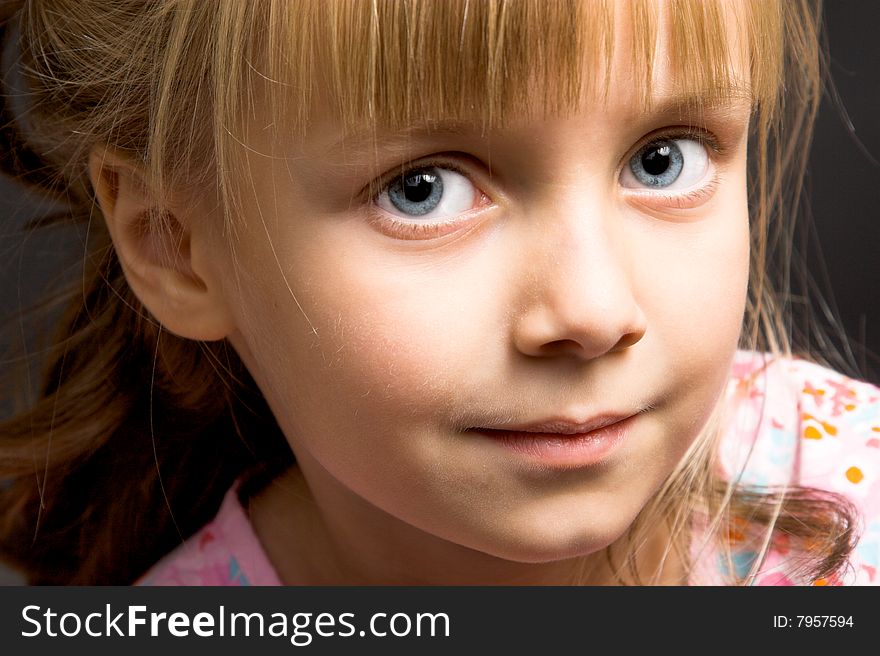 Blond Girl with big blue eyes on a black background