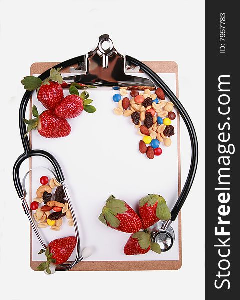 Healthy eating concept, fruits and nuts on clipboard with stethoscope