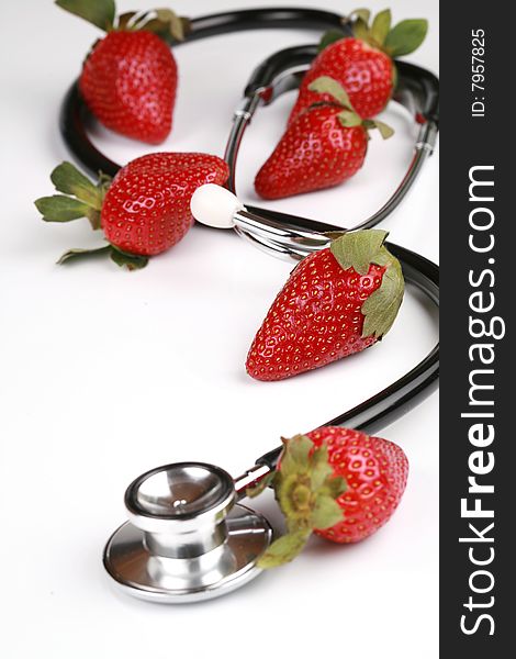 Healthy snack, Stethoscope with strawberries isolated. Healthy snack, Stethoscope with strawberries isolated