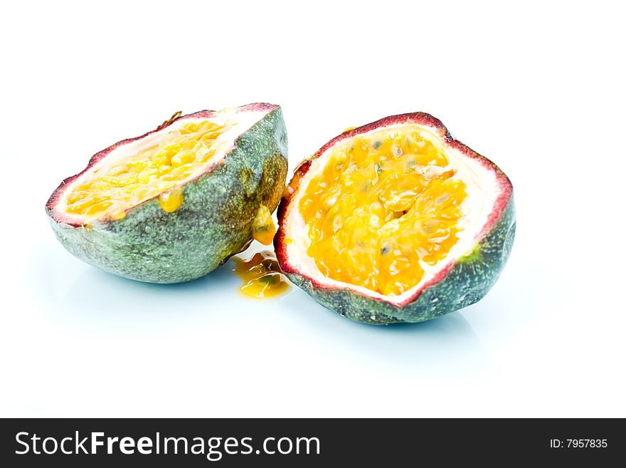 A fresh halved passion fruit on white