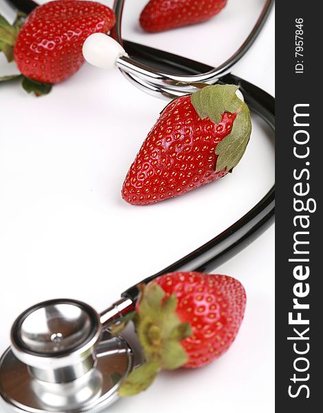 Healthy snack, Stethoscope with strawberries isolated. Healthy snack, Stethoscope with strawberries isolated