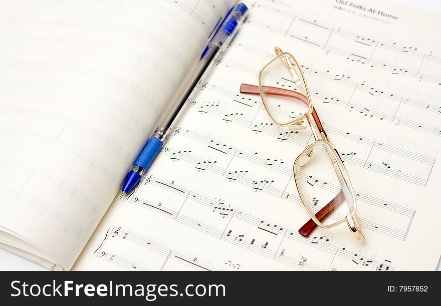 Glasses and pencil on book of notes