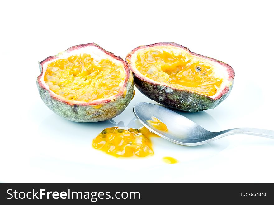 A fresh halved passion fruit with spoon
