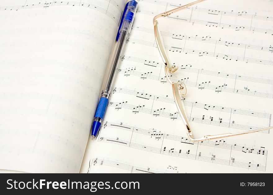 Glasses and pencil on book of notes